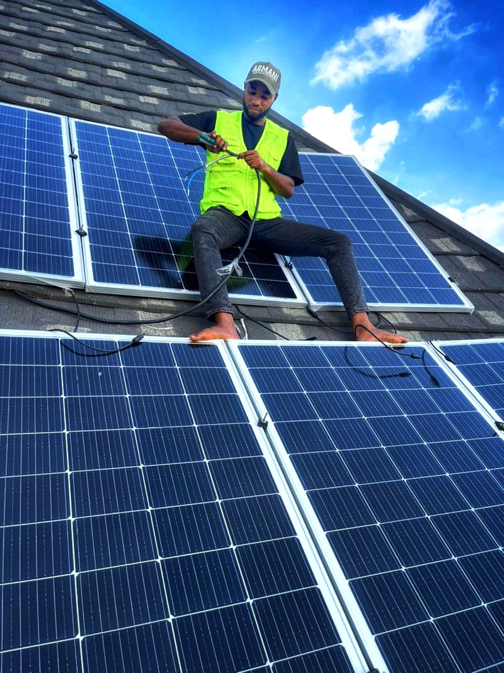 Installer on residential rooftop, Nigeria